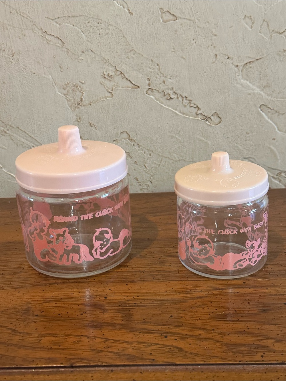 2 Vintage 1950s "Round The Clock With Baby" Glass Nursery Jars